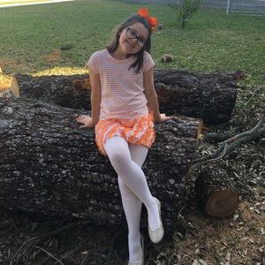 Cute girl’s orange and while T-shirt dress.